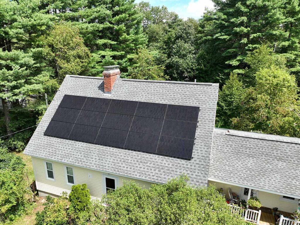 Side view of a green home in MA with solar panels.
