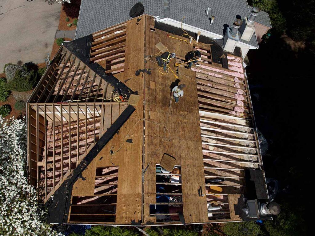 Golden Group Roofing doing a roof replacement due to delayed roof repairs in Massachusetts.