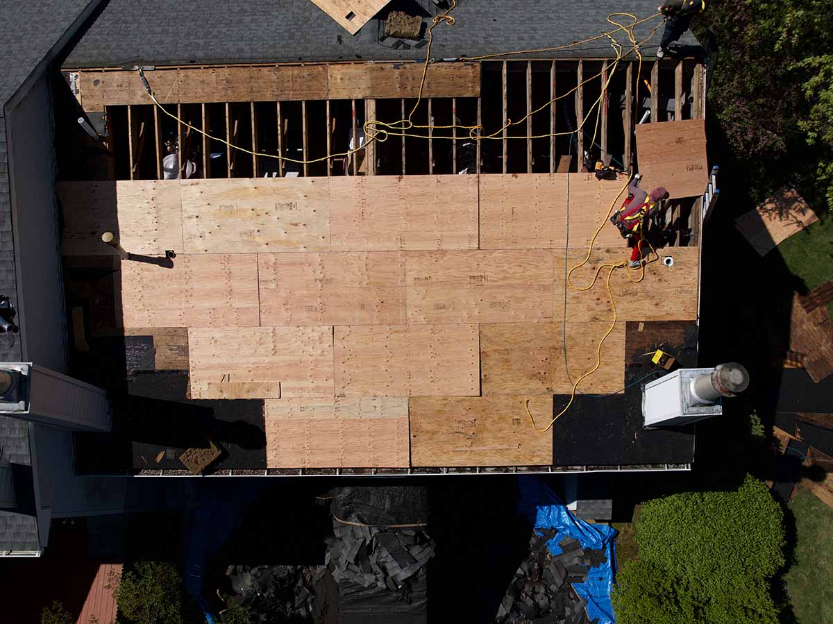Aerial view of roof repair and replacement due to delayed roof repairs.