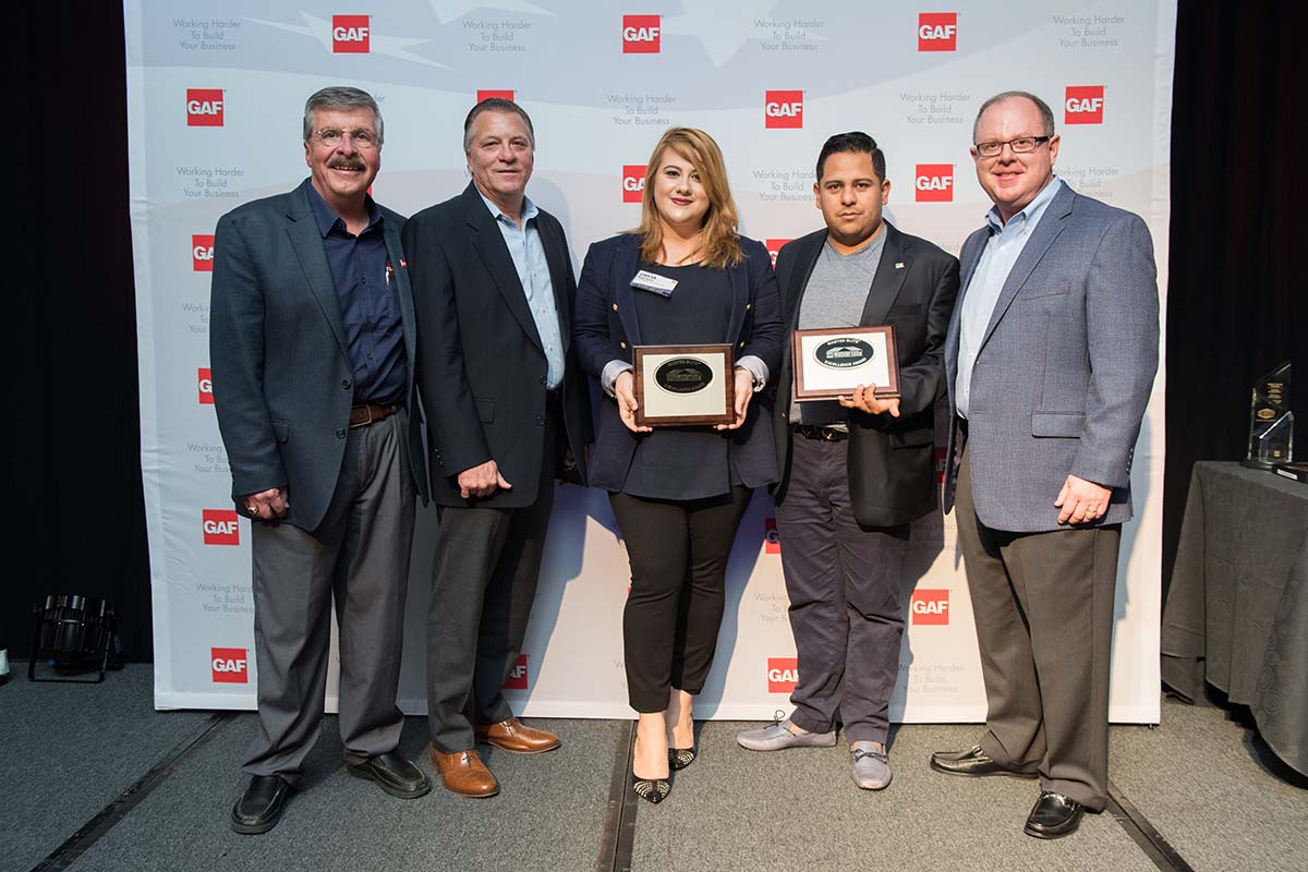 Golden Group team with GAF sign in background.How To Find a Roof Warranty that Guarantees Protection.