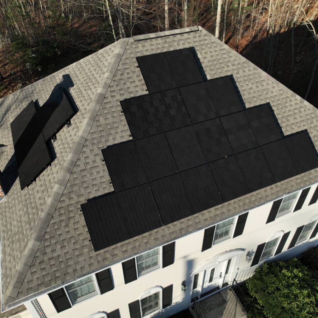 Rooftop of a modern home featuring solar panels installed in Massachusetts.