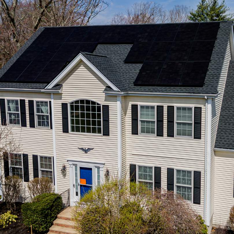 a image of House undergoing renovation with newly installed solar panels on the roof and energy-efficient siding, enhancing the home's energy efficiency and appearance.
