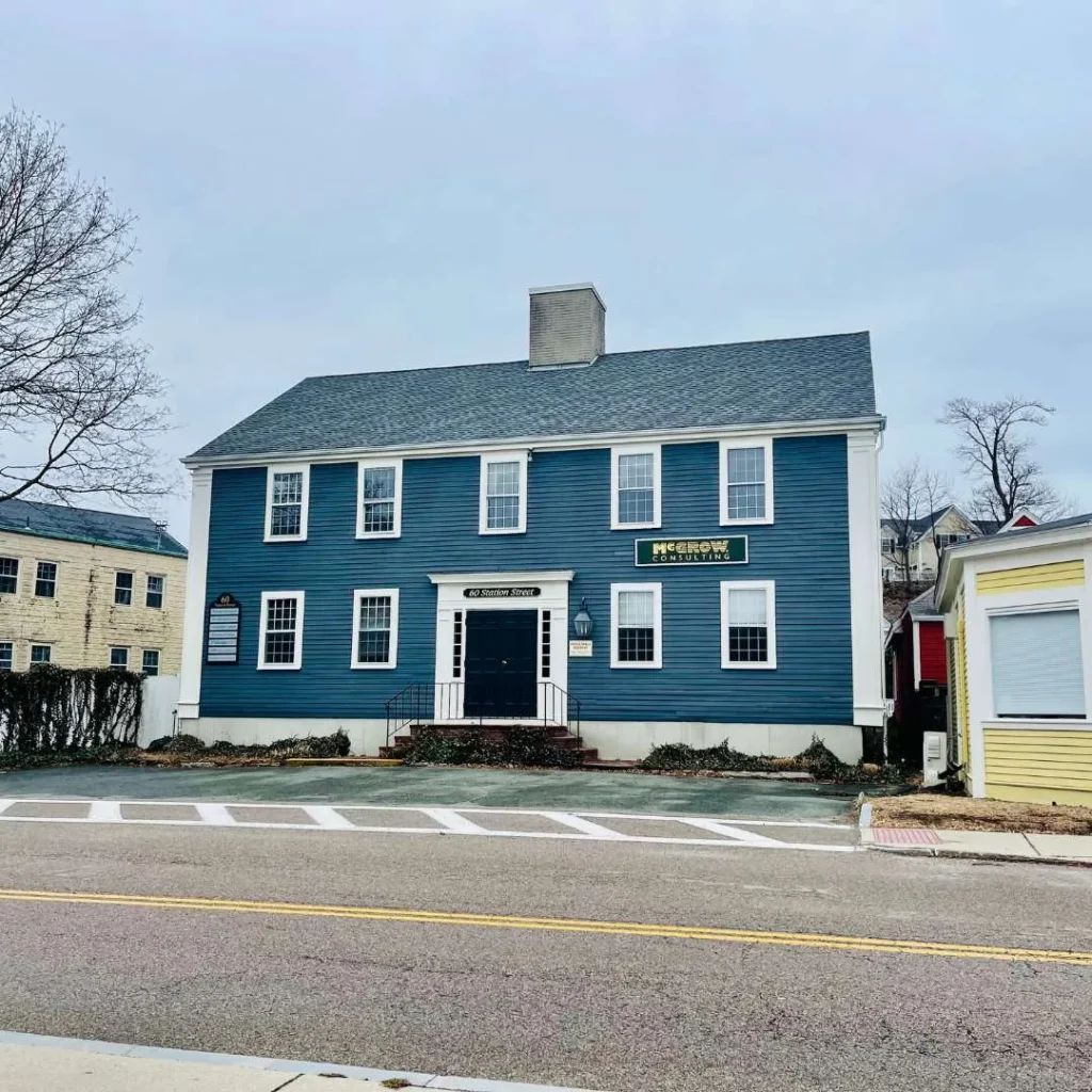Street view of the Golden Groups Hingham office with blue siding and steps to the front doors.