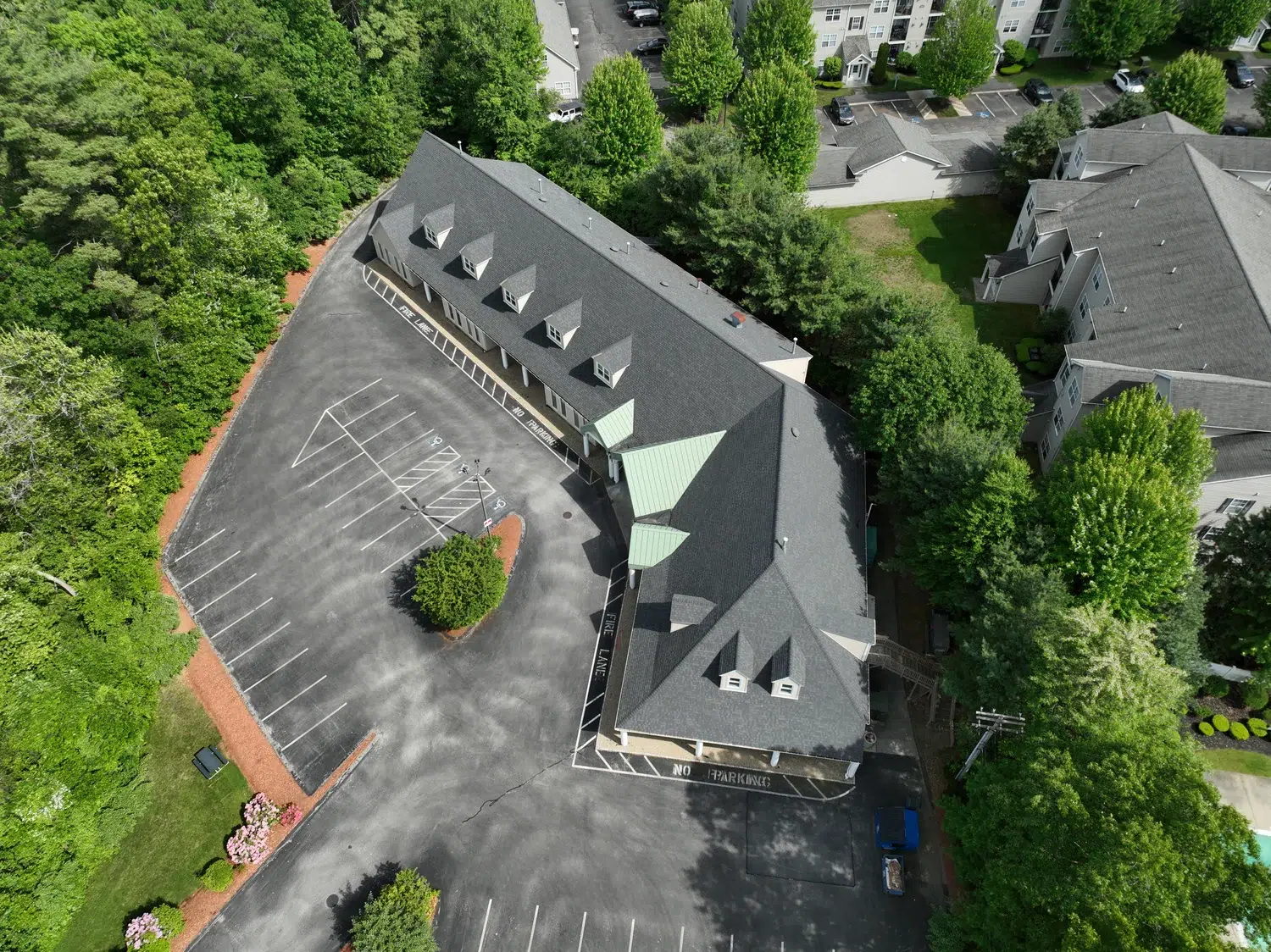 Complete Roof Replacement project on a local business in Worcester, Massachusetts with a new shingled roof.