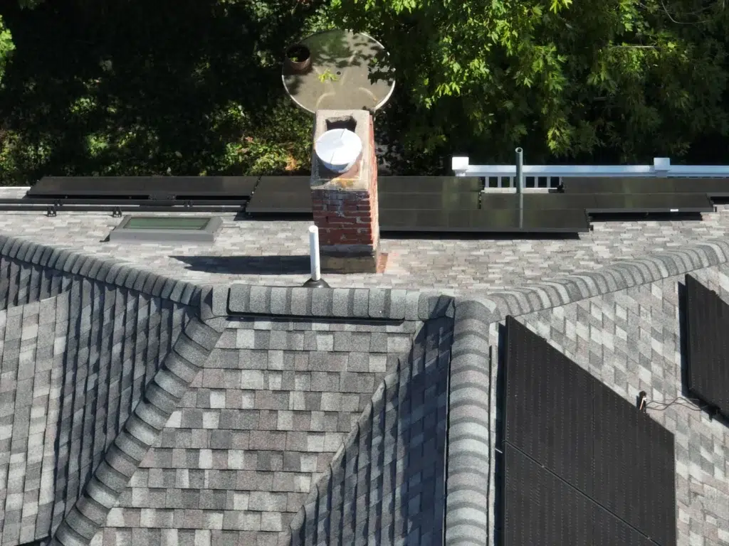 Aerial view of a Completed Solar Roofing Solution project on a shingled roof in Cambridge, Massachusetts