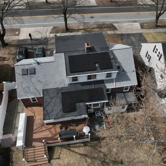 Aerial view of Rooftop Solar Panels on two separate roofs completed by Golden Group Roofing in Newton, Massachusetts