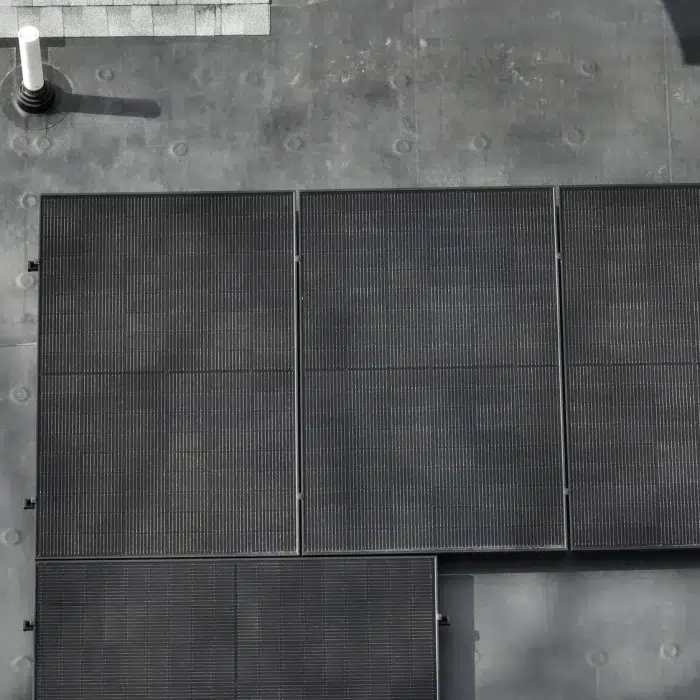 Aerial view of a Home Solar Power Setup installed on a flat roof in Marlborough, MA by Golden Group Roofing