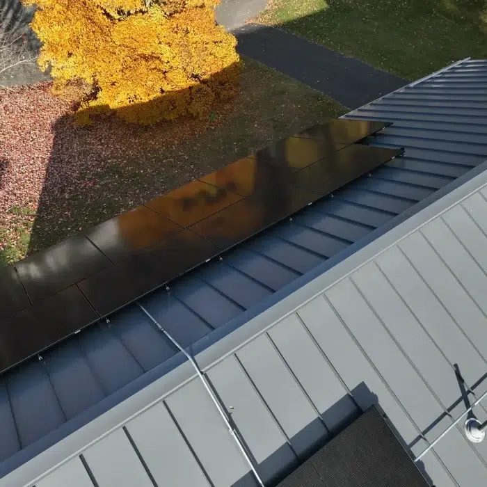 Aerial view of a Solar Panel Installation on a slanted metal rooftop in Framingham, MA