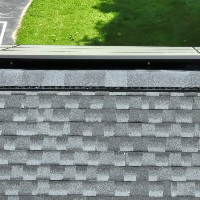 Solar Panel Installation set up on a slanted shingled rooftop in Framingham, MA by Golden Group Roofing