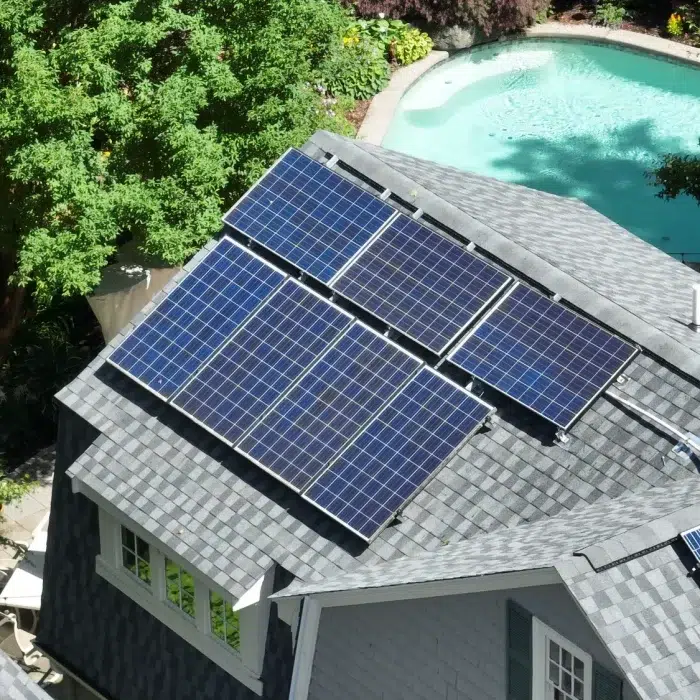 Aerial view of a Completed Solar Roofing Solution project on a shingled roof in Hudson, MA by Golden Group Roofing