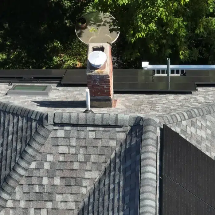 Aerial view of a Completed Solar Roofing Solution project on a shingled roof in Cambridge, Massachusetts