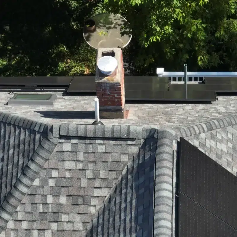 Aerial view of a Completed Solar Roofing Solution project on a shingled roof in Cambridge, Massachusetts