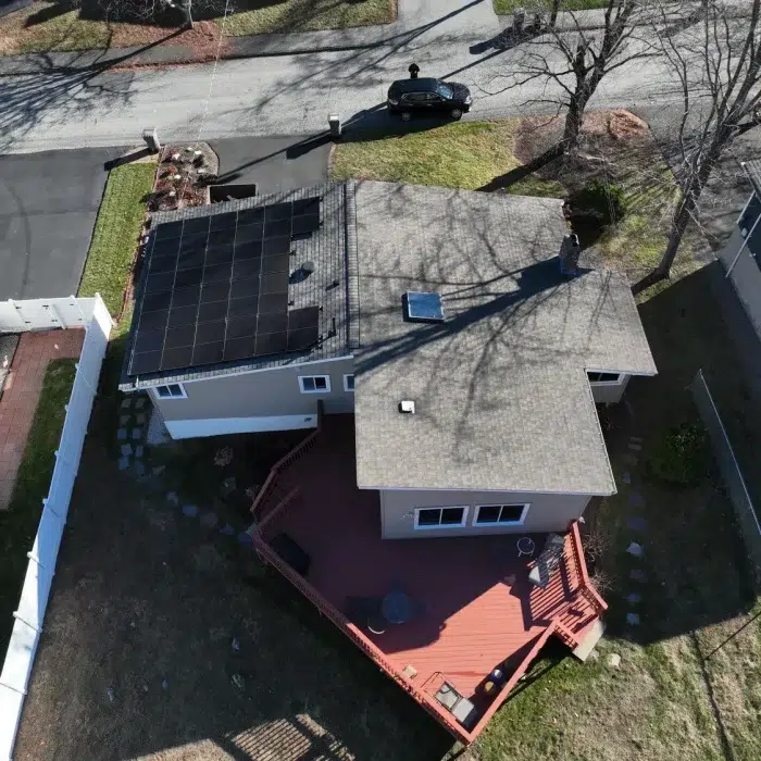 Aerial view of a residential home with a slanted rooftop with Solar Panels installed in Newton, Massachusetts