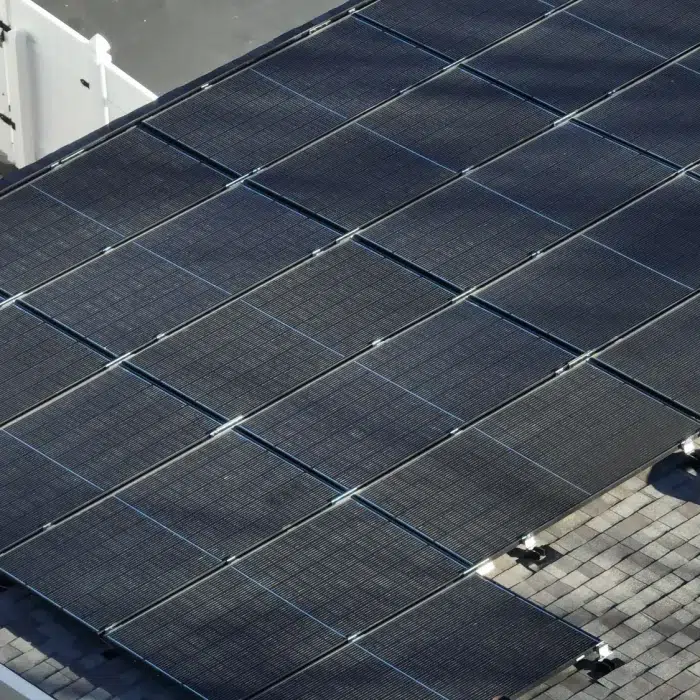 Aerial view of a flat Rooftop Solar Panels in Newton, Massachusetts on a shingled roof