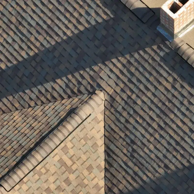 Aerial view of a Roof Construction Project in Hopkinton, MA with new shingles and chimney