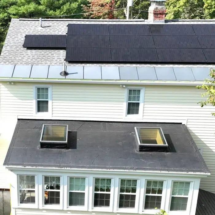 Aerial view of a Completed Solar Roofing Solution project on a shingled roof in Westborough, MA by Golden Group Roofing