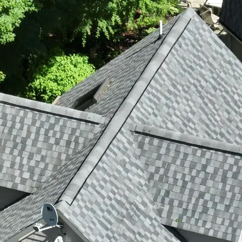 Aerial view of a new Full Roof shingle Installation in Sudbury, MA with a skylight