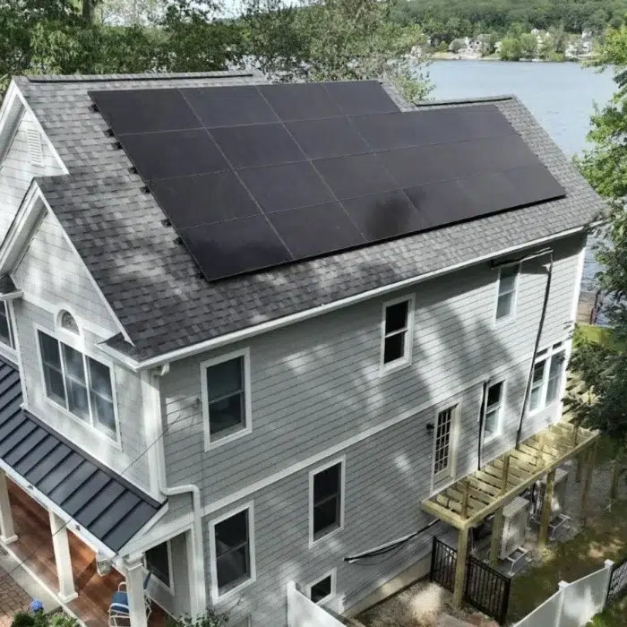 Aerial view of a Home Solar Upgrade rooftop on a residential lake home in Shrewsbury, MA